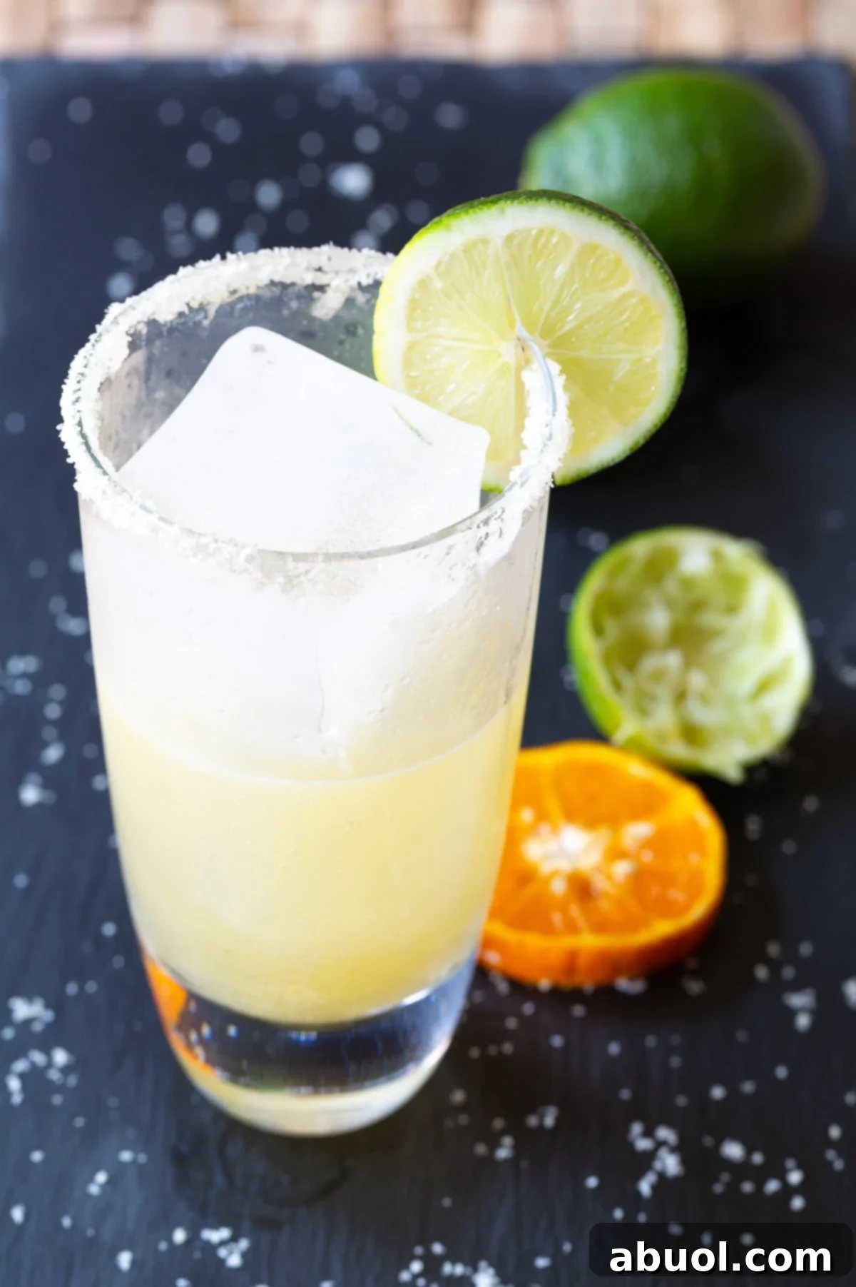 A large, inviting margarita being poured and served into a glass, indicating a generous and refreshing drink.