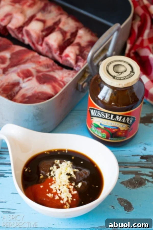 Closeup view of ramekin filled with Musselman's apple butter, garlic, Sriracha, soy sauce and fish sauce.