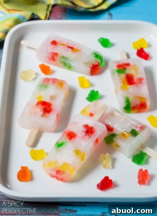 Vodka Gummy Bears Pops: Vibrant, sparkling, and perfectly boozy popsicles ideal for any adult summer celebration.
