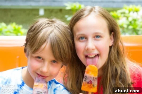 Kid Friendly Pops: Delicious and colorful gummy bear popsicles, a perfect non-alcoholic treat for children on hot summer days.