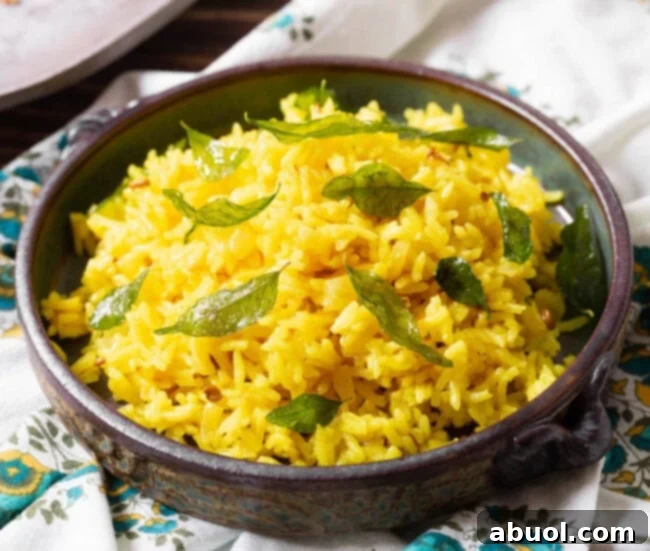 Indian rice in a bowl with curry leaves on top, showcasing its aromatic appeal and fluffy texture.