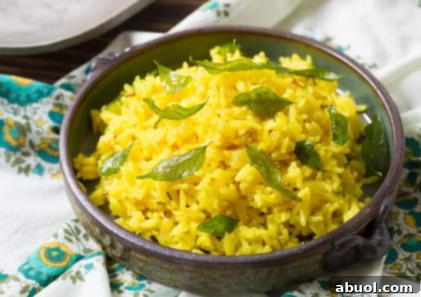 Indian Rice in a bowl garnished with fresh green curry leaves, ready to be served as a delightful side.