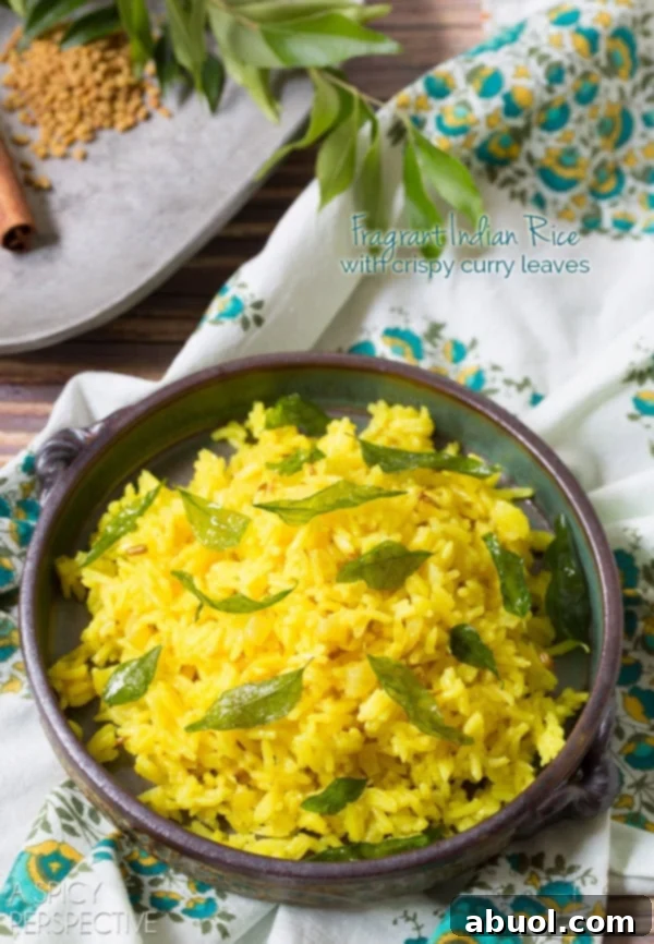 Fragrant Indian Turmeric Rice in a bowl with crispy curry leaves on top, ready to be enjoyed as a gourmet side dish.