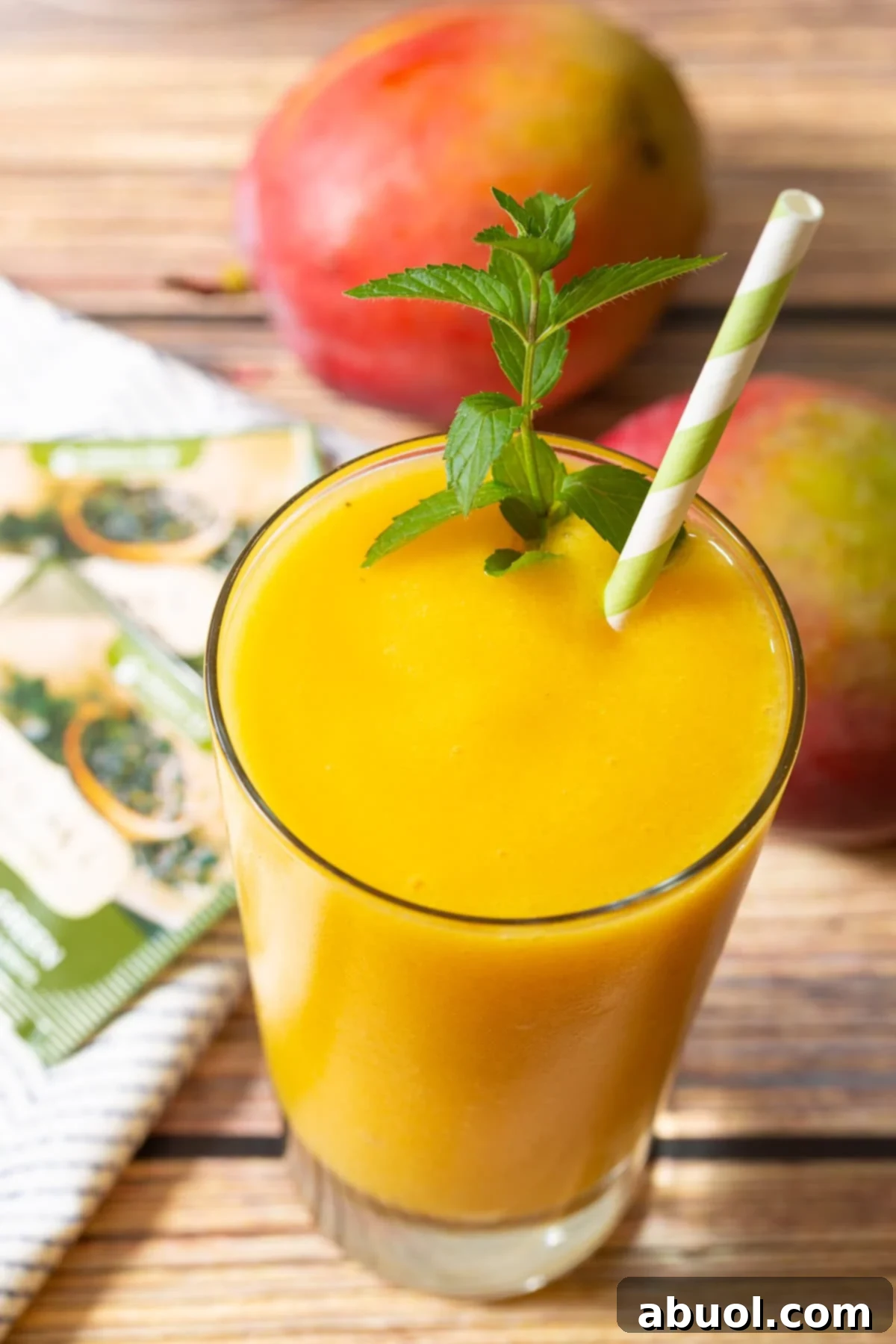 A vibrant Mango Green Tea Smoothie, garnished with fresh mint, signaling a refreshing and healthy start to the day.