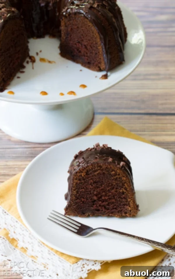 Boozy Baileys Bundt Bliss 5 A plated slice of Baileys Irish Cream Bundt Cake with a fork, ready to be enjoyed.