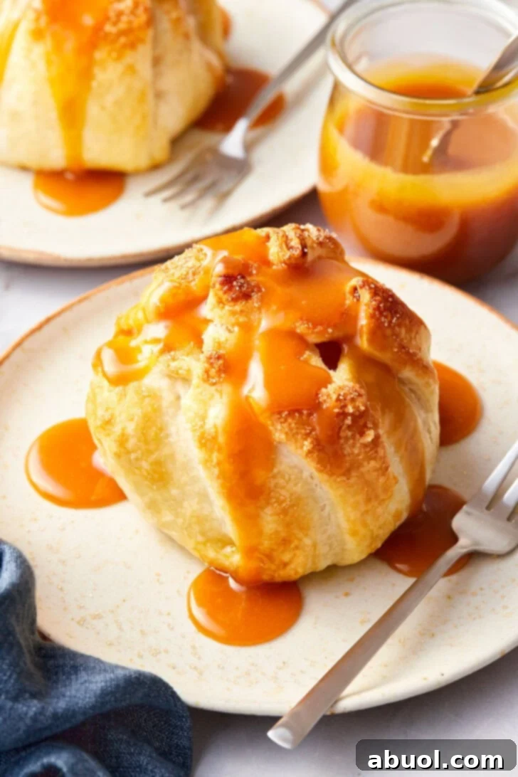 Simple baked apple recipe with puff pastry on a plate, caramel sauce over the top