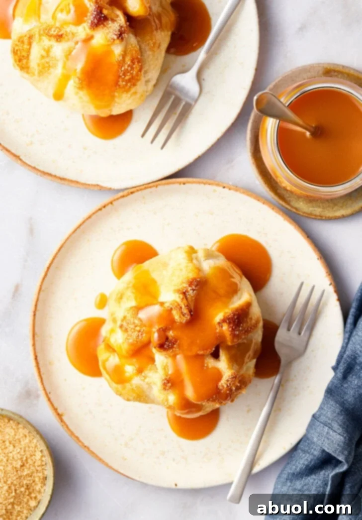 Baked apple recipe after being baked on a plate with caramel on top, overhead shot.