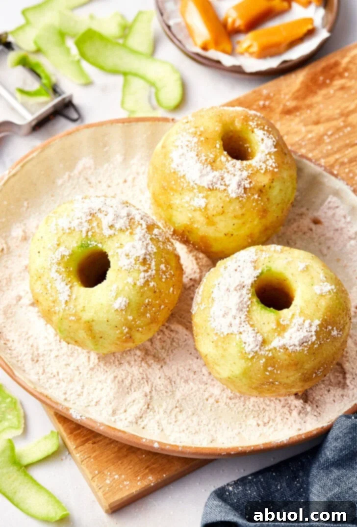 Peeled apples rolled in sugar and spices for mini apple pies recipe.