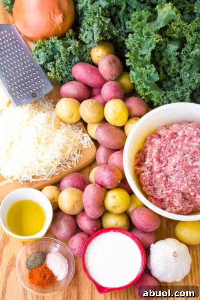 Sausage and kale soup ingredients laid out on a wood surface.