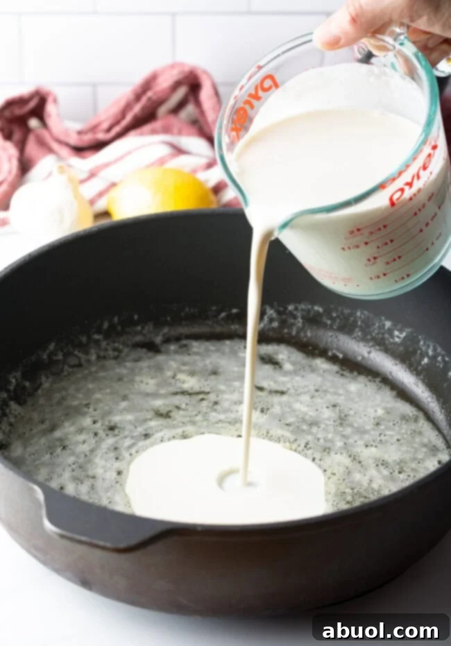 Cream simmering in a pan for Alfredo sauce