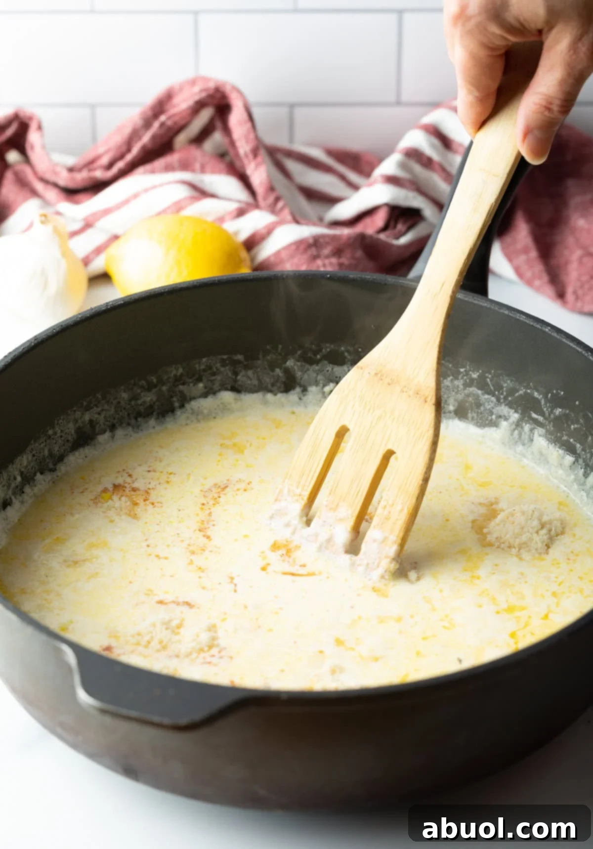 Fettuccine Alfredo recipe ingredients coming together in a skillet