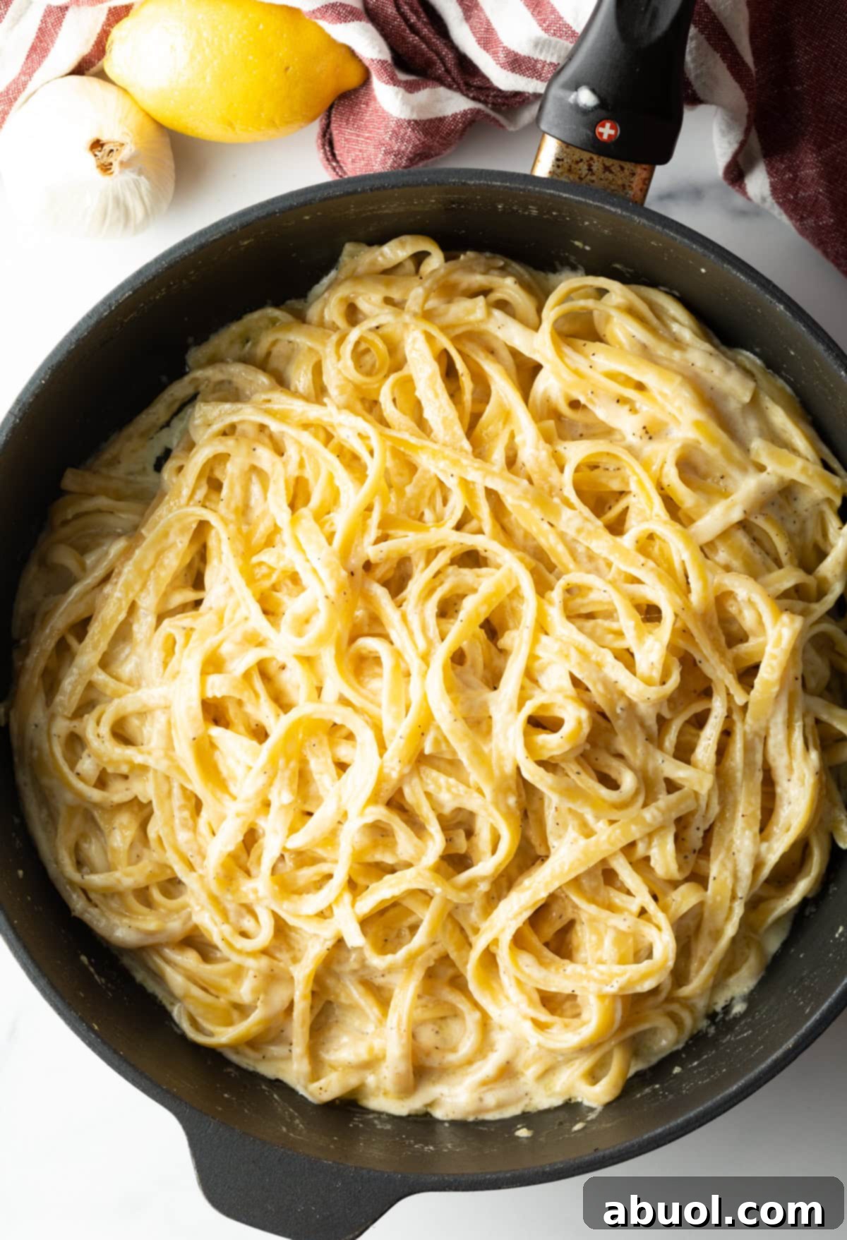 Close-up of a bowl of homemade Fettuccine Alfredo garnished with parsley