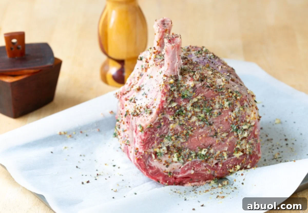 Close-up of the standing rib roast liberally coated with the flavorful mustard and seasoning mixture.