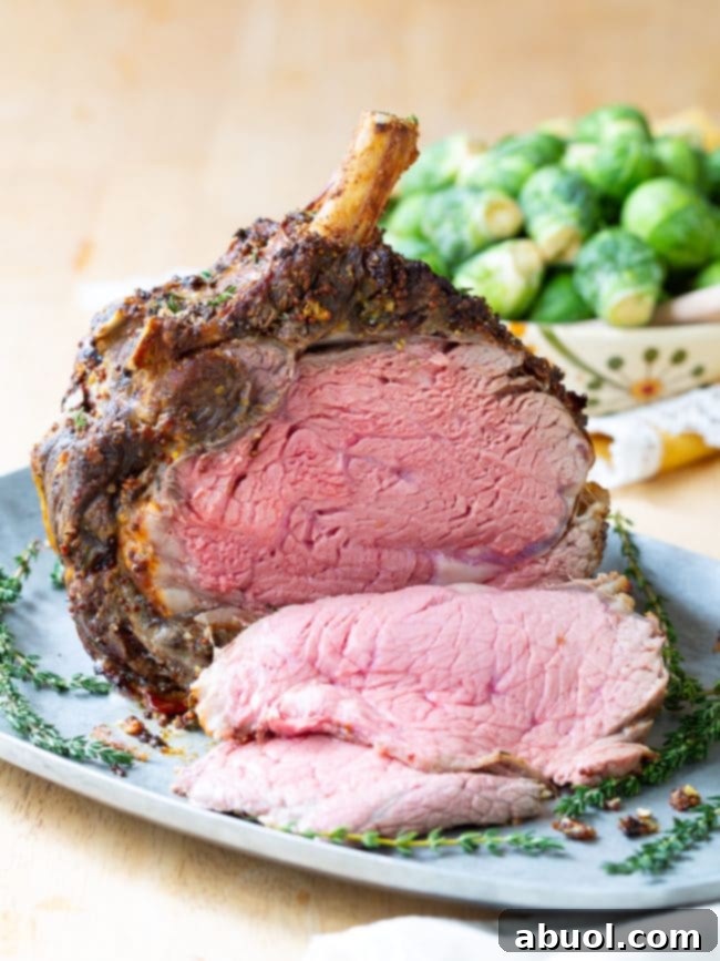 A large, perfectly roasted standing rib roast with a golden crust, presented on a platter.