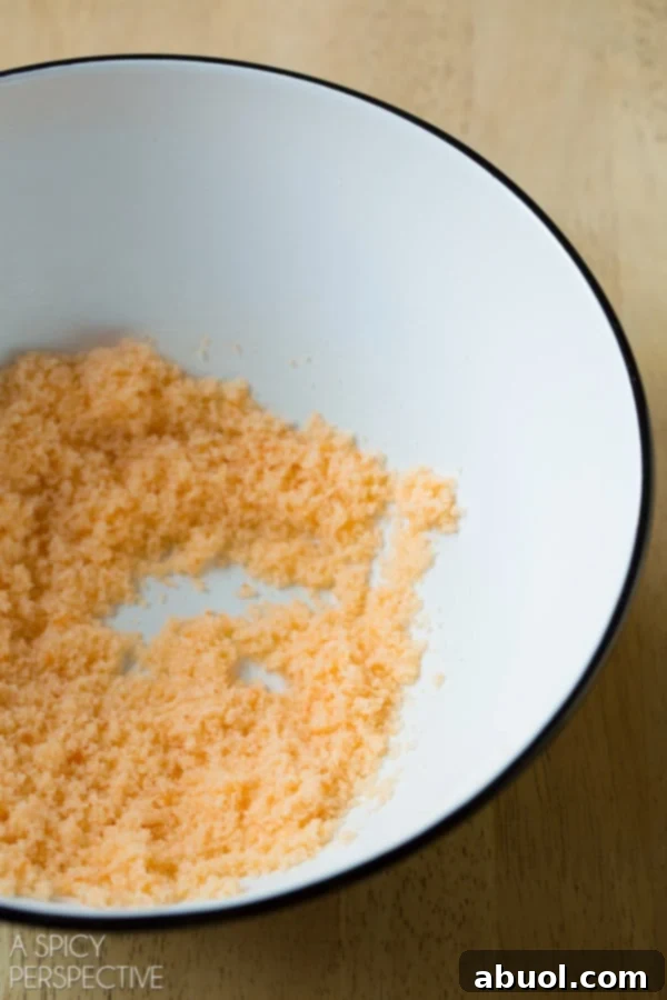 How to Make Flavored Sugars - various ingredients being mixed in a bowl before jarring.