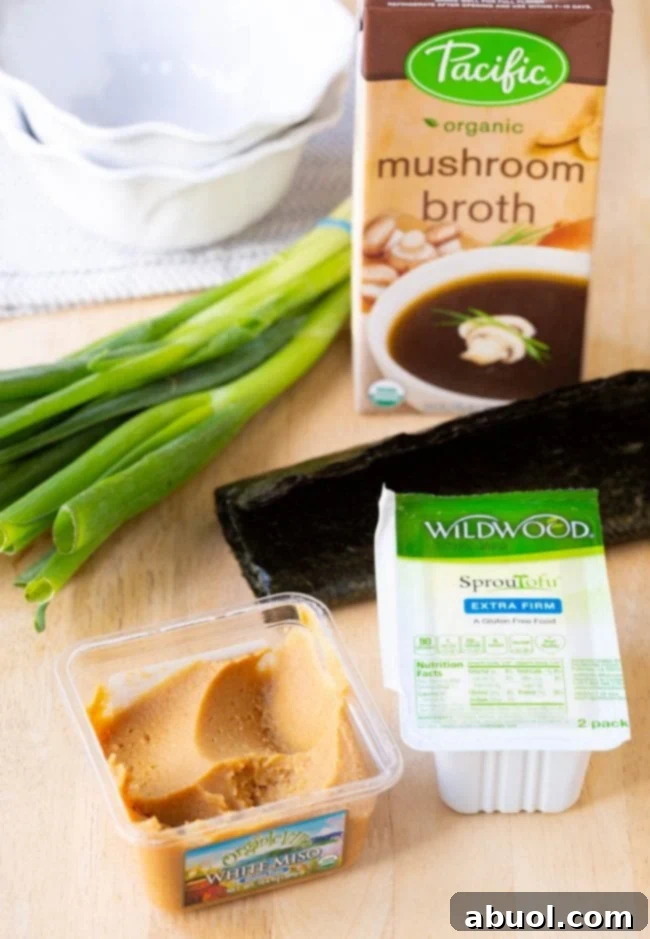 A flat lay photograph showcasing all the fresh and essential ingredients needed to make a quick 5-minute Japanese Miso Soup recipe.