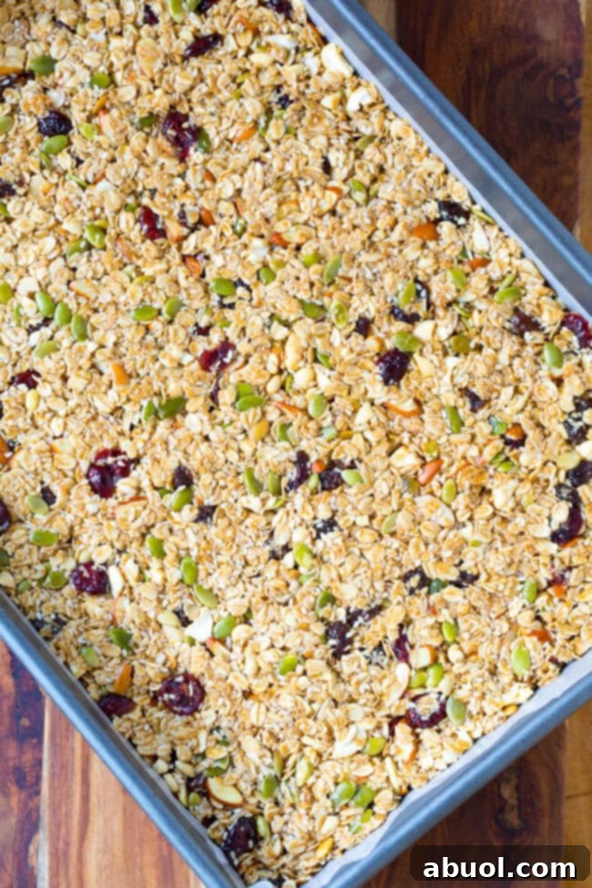 Granola bar mixture spread in a flat layer on a baking sheet, pressed firmly.