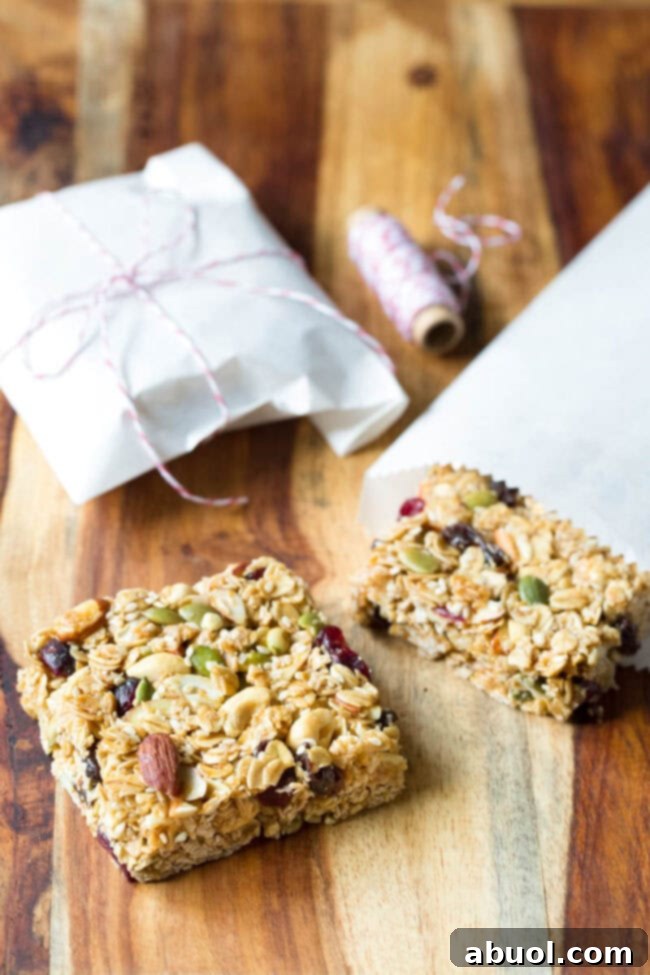 Homemade granola bars on a wooden cutting board, perfectly cut and ready to eat.