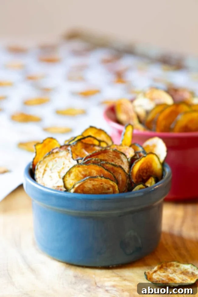 Crispy Baked Zucchini Chips served in a rustic blue bowl, ready for a healthy snack.