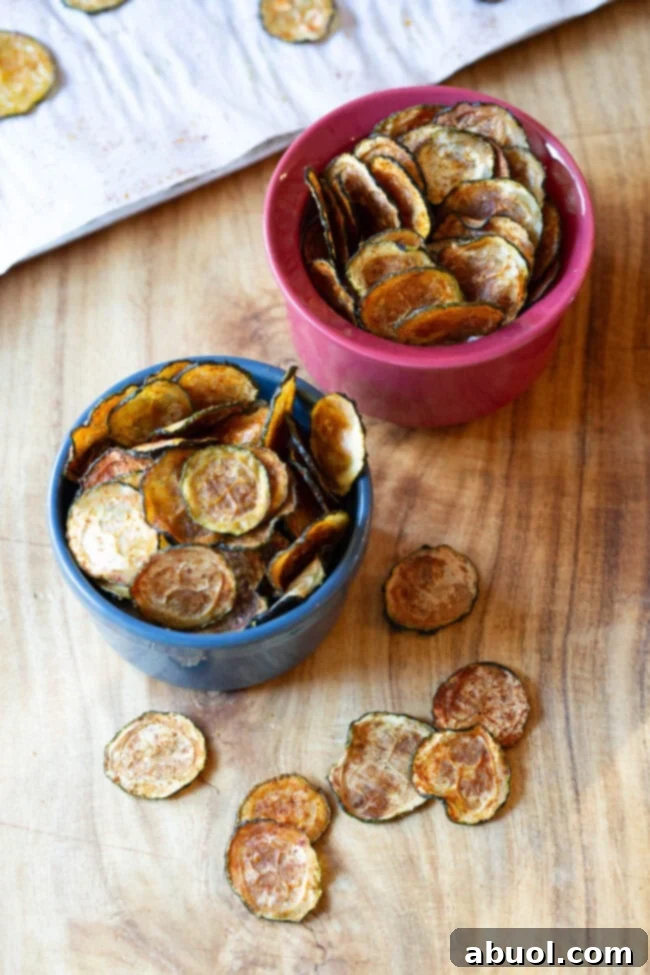 Assortment of zucchini chips served in small individual bowls, showcasing different seasoning possibilities.