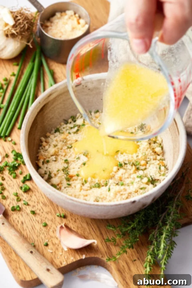 Small bowl containing a mixture of parmesan cheese, herbs, and breadcrumbs for the salmon crust.