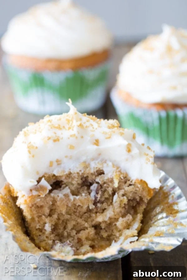 Close-up of a half-eaten hummingbird cupcake, showing its moist crumb and rich frosting.
