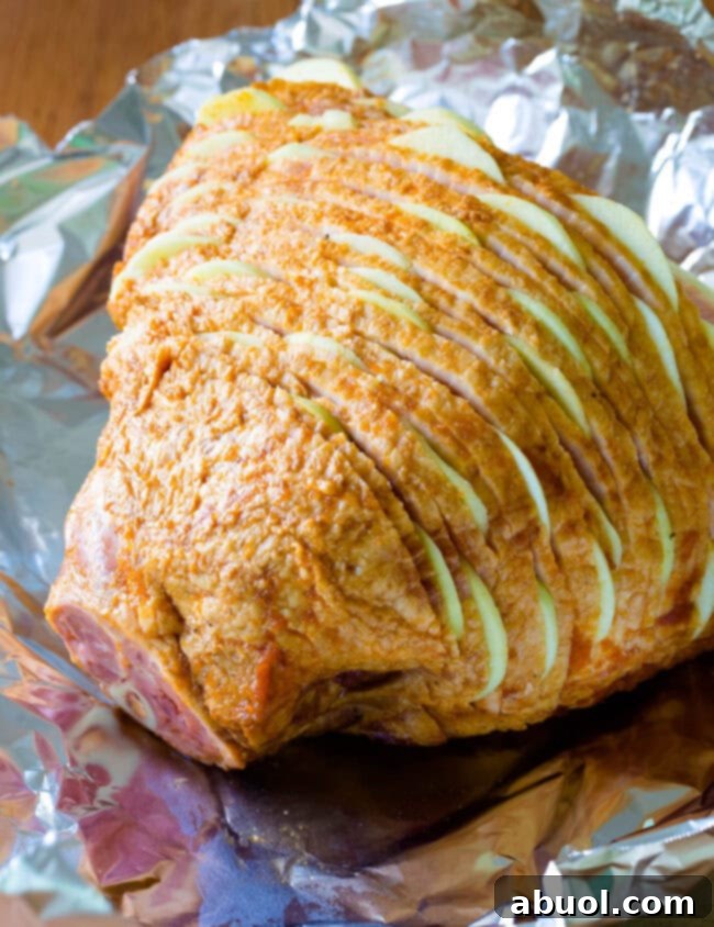 Ham with apples tucked in between the layers before getting baked.