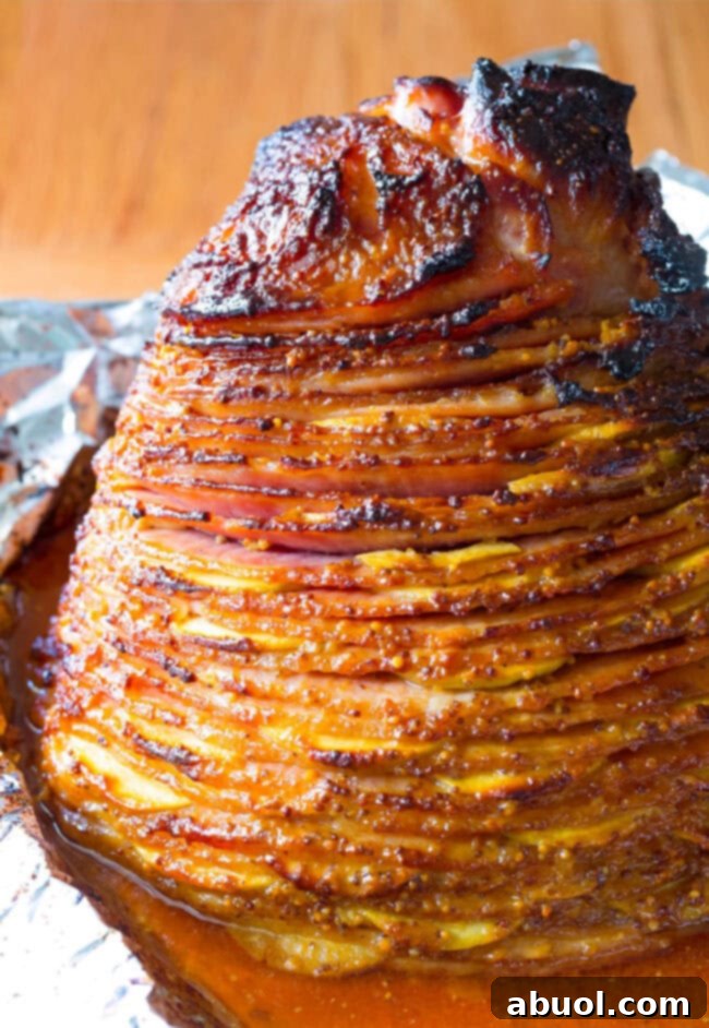 Fully Cooked Apple Stuffed Ham with Mustard Glaze on the baking sheet.