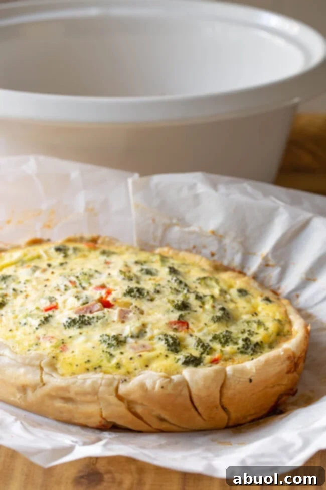 Cooked breakfast quiche on a piece of parchment paper.