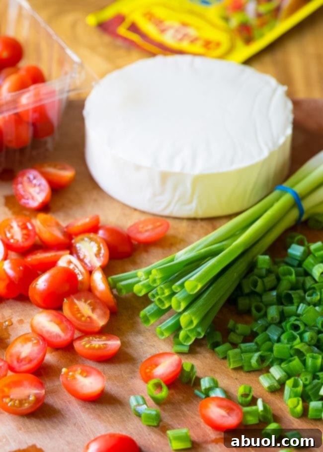 Ingredients needed for grilled chicken salad recipe. These include scallions, grape tomatoes, cheese and fajita seasoning.