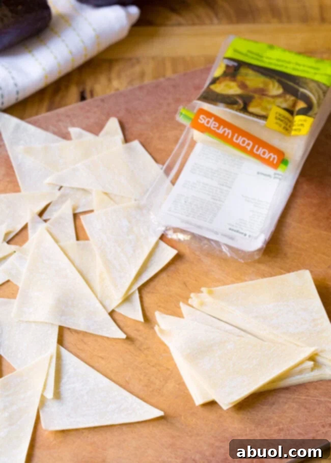 Piles of raw wonton triangles.