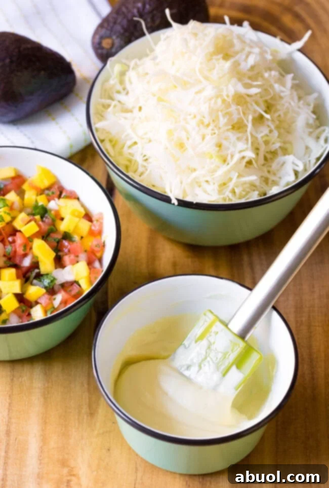 Stirring wasabi mayo in a small bowl with a rubber spatula.