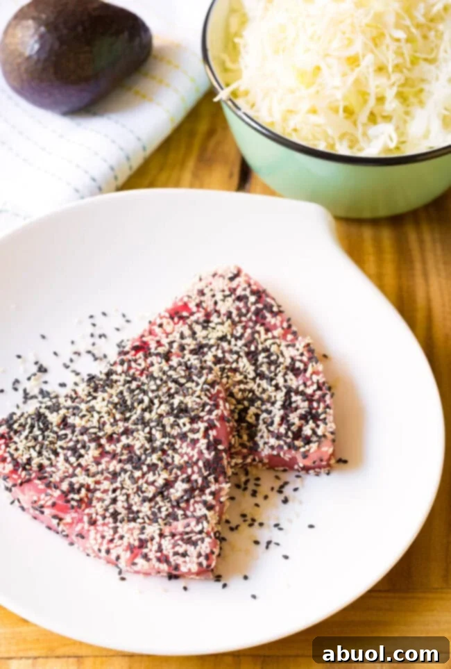 Two raw ahi tuna steak coated with sesame seeds.