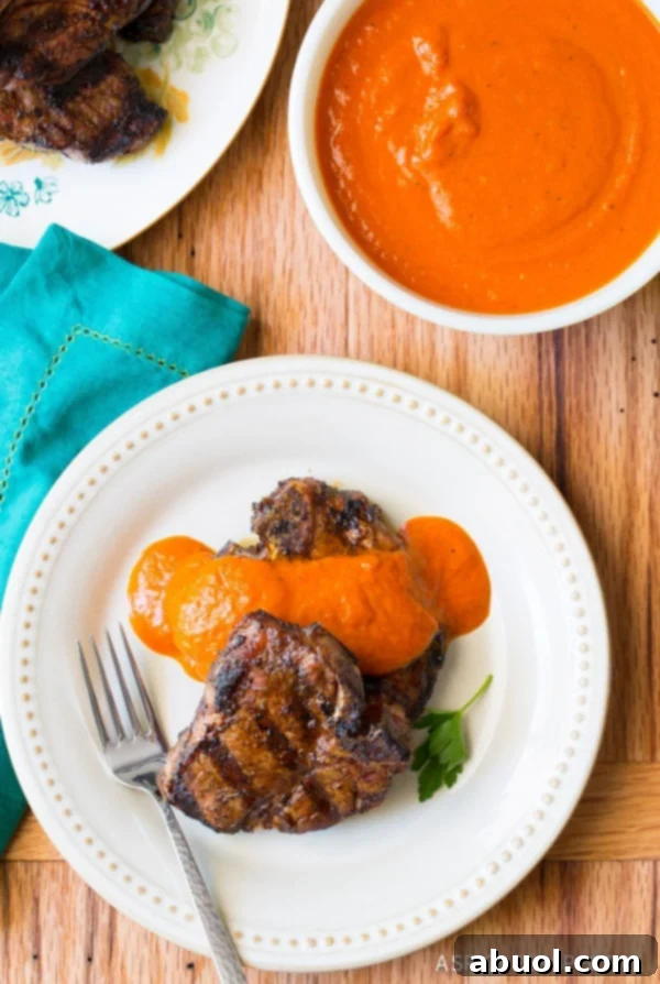 Gorgeous Chipotle Lime Grilled Lamb Chops with Ranchero Sauce overhead shot on plate with fork