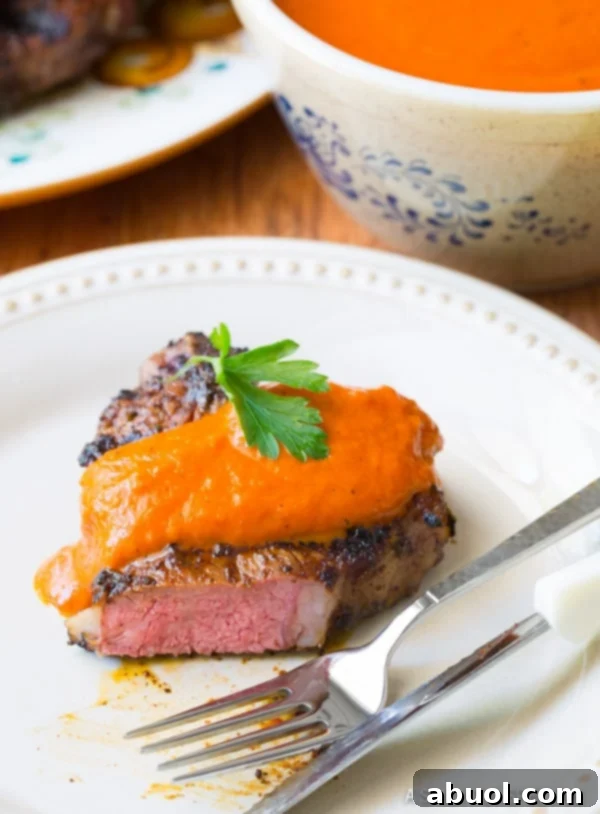 The Best Grilled Lamb Chops - cut open to show perfect medium-rare