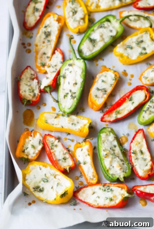 Flavorful Stuffed Mini Pepper Poppers 2 Love these 3-Ingredient Mini Stuffed Peppers Recipe on baking sheet