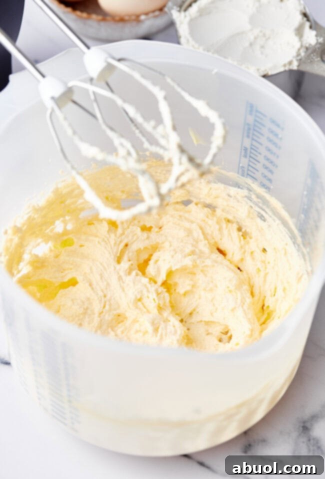 Beaters above a mixing bowl with muffin batter.