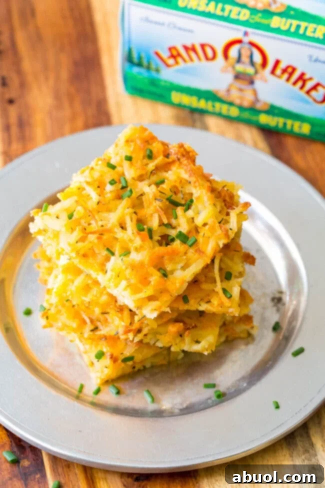 Platter of crispy baked hash browns, cut into neat squares, ready for serving or topping.