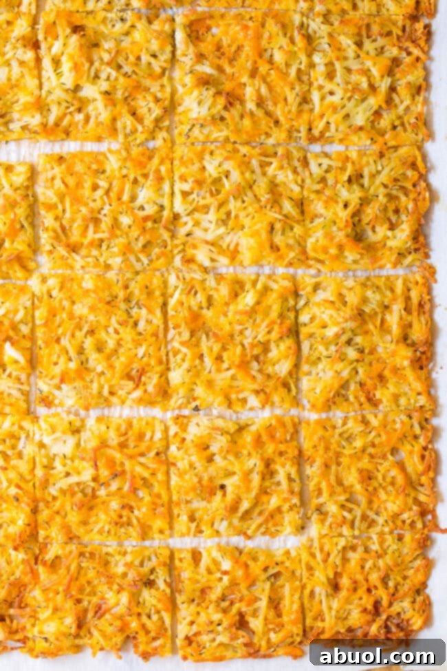 Crispy oven-baked hash browns, neatly cut into squares and stacked, showcasing their golden texture.