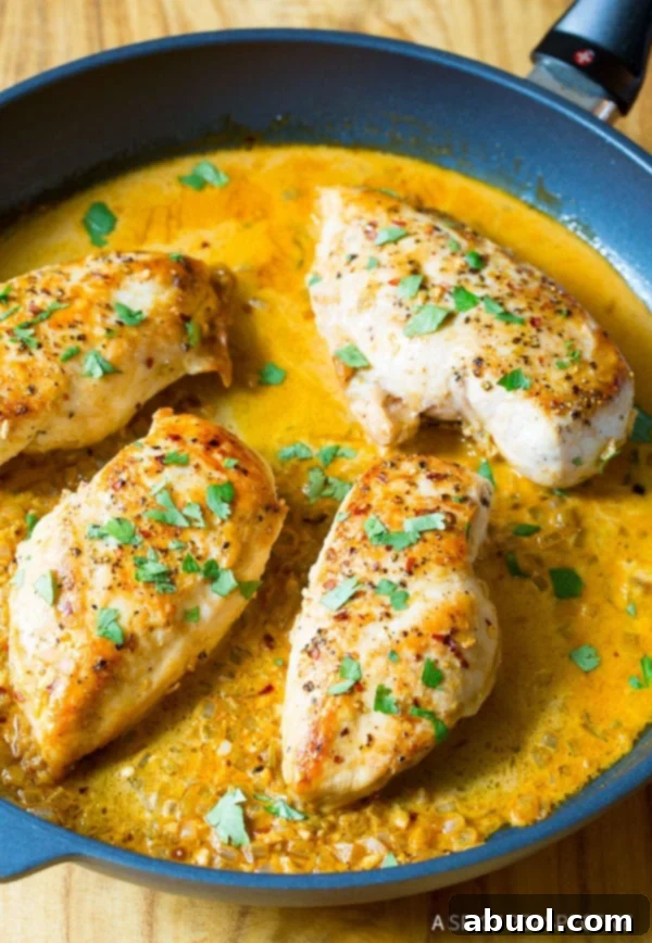 Garlic Lime Skillet Chicken: An Easy & Flavorful Weeknight Dinner Recipe Perfectly seared Garlic Lime Chicken breast in a pan, glistening with a vibrant yellow sauce and fresh cilantro garnish, ready to be served.