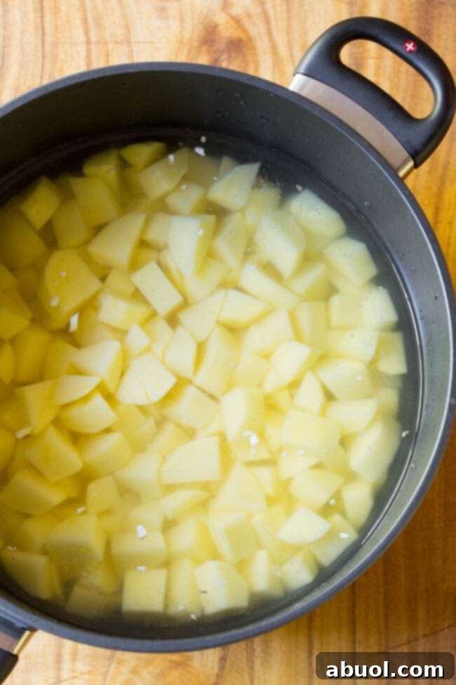 Chopped up potatoes in a pot ready to boil and become tender
