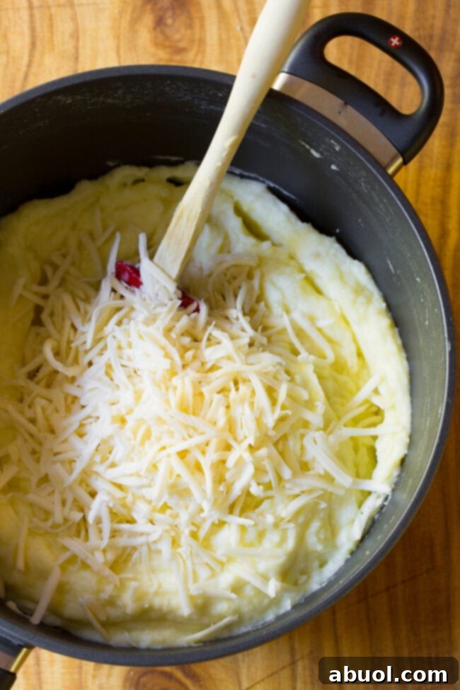 top view of mashed potatoes with cheese ready to stir in