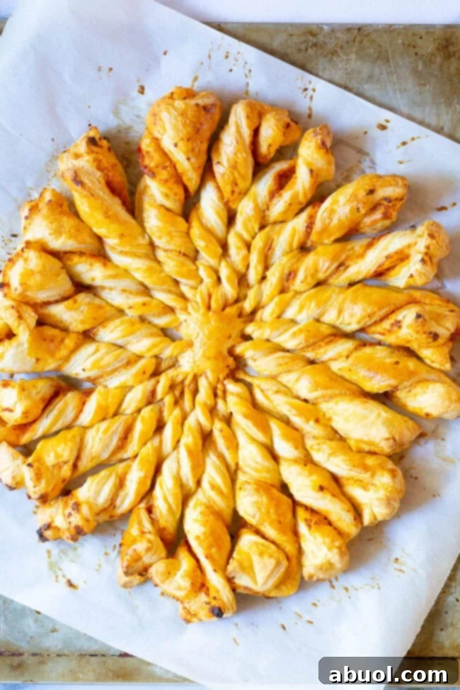 Overhead view of a freshly baked Sunburst Pull Apart Bread, half eaten, revealing the twisted layers and cinnamon sugar filling.