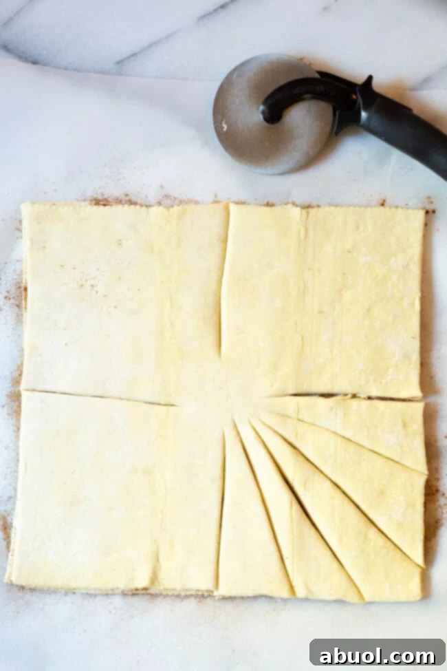 Two sheets of puff pastry layered, cut into four sections with an uncut center.