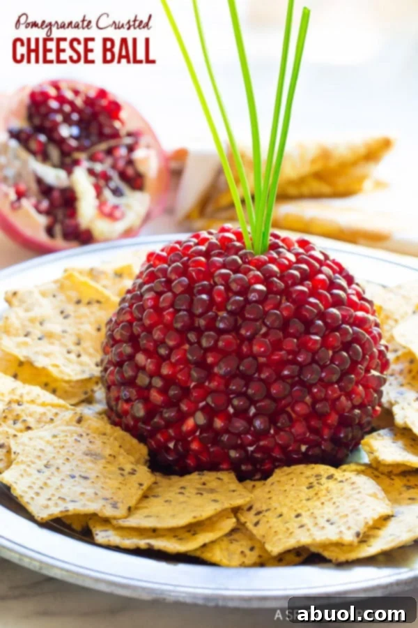 Pomegranate Cheese Ball Recipe on plate with crackers