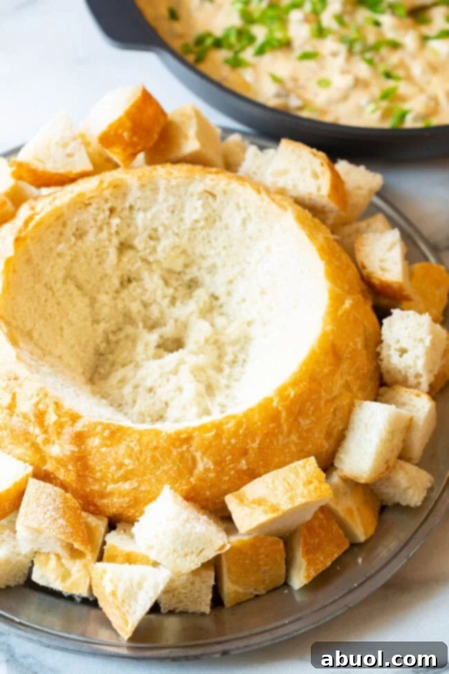 A hollowed out loaf of sourdough bread for cheese dip.