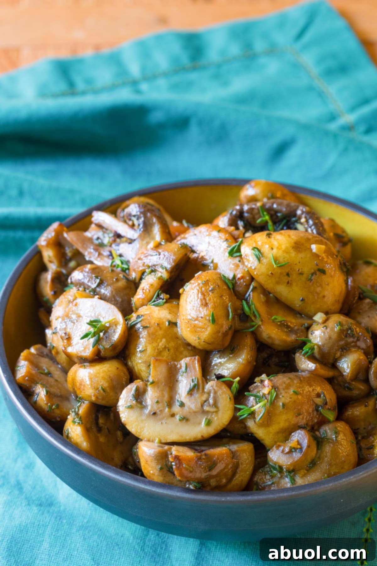Close-up of perfectly sautéed mushrooms in a skillet, showcasing their golden-brown color and rich glaze, ready to be served.