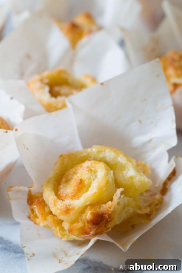 Close up shot of a French pastry, emphasizing its rich, flaky layers and delicate structure.