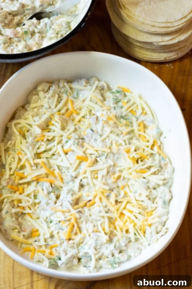 Layering tortillas and cheese in the casserole dish