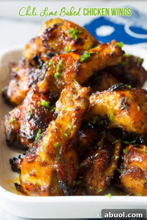 Chili Lime Chicken Wings White baking dish loaded with chicken wings coated in chili lime sauce, baked crispy and ready for serving.
